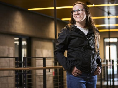 image of female student looking off into the distance and smiling 
